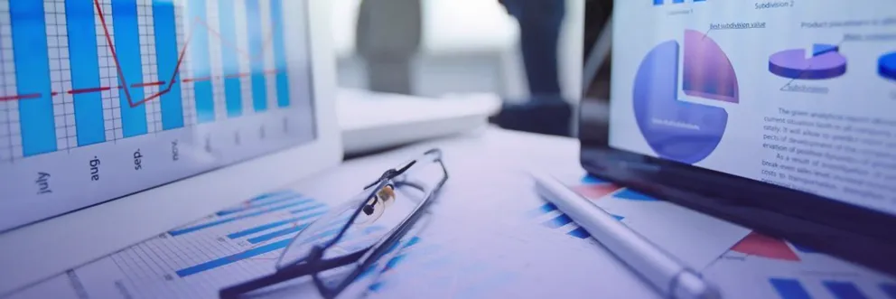 A close-up of digital analytics dashboards and charts on tablets and laptops, representing data analysis and business insights